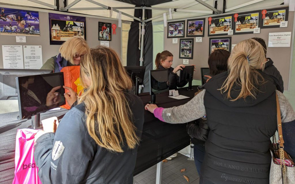 people choosing and ordering photos at a live horse show event