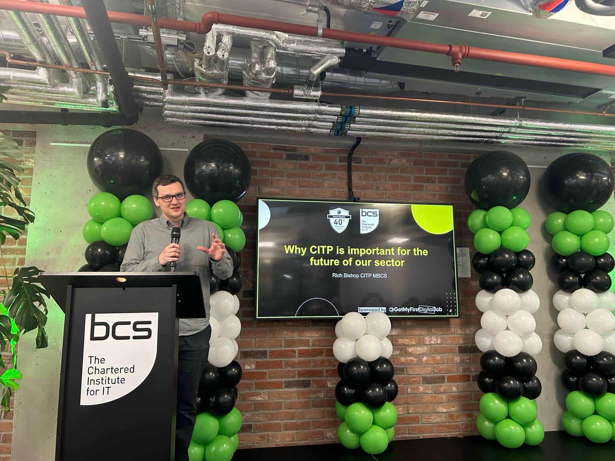 Rich Bishop delivering a speech on stage at BCS London Office