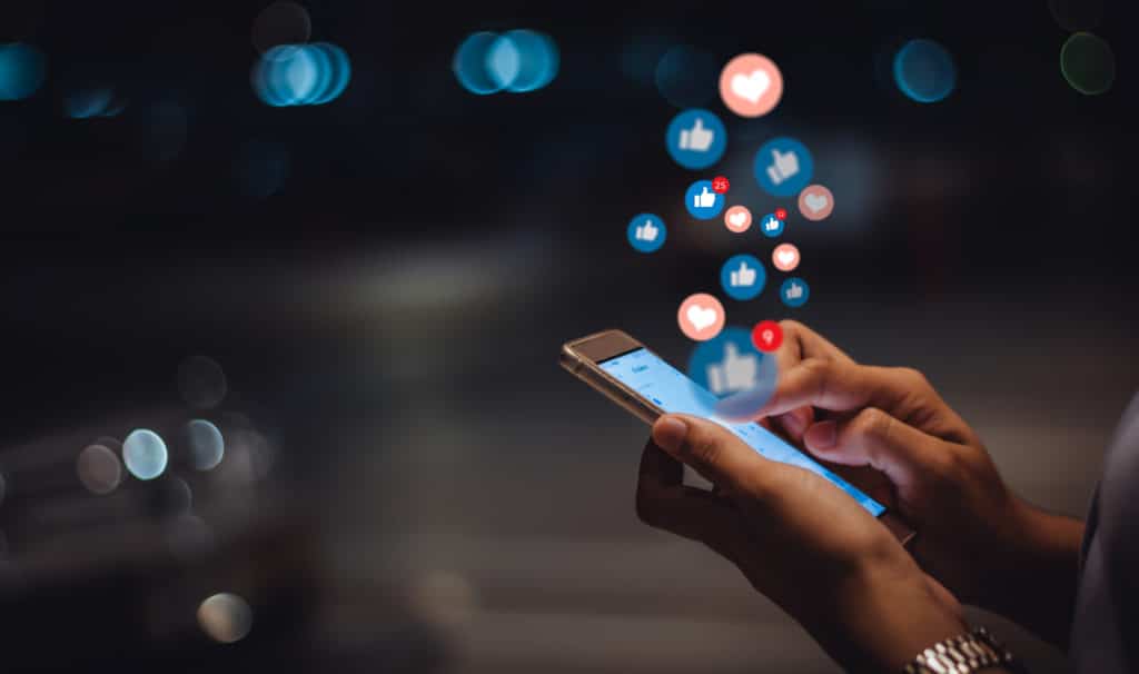 Person engaging with social media posts on a mobile phone
