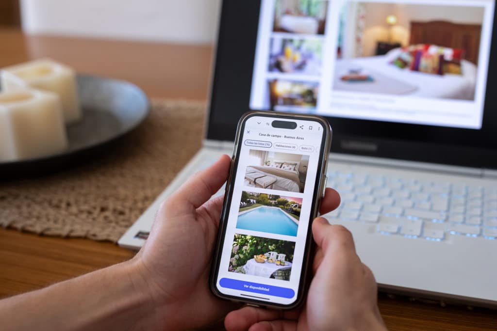 Person using AI powered search engine on a mobile phone and laptop